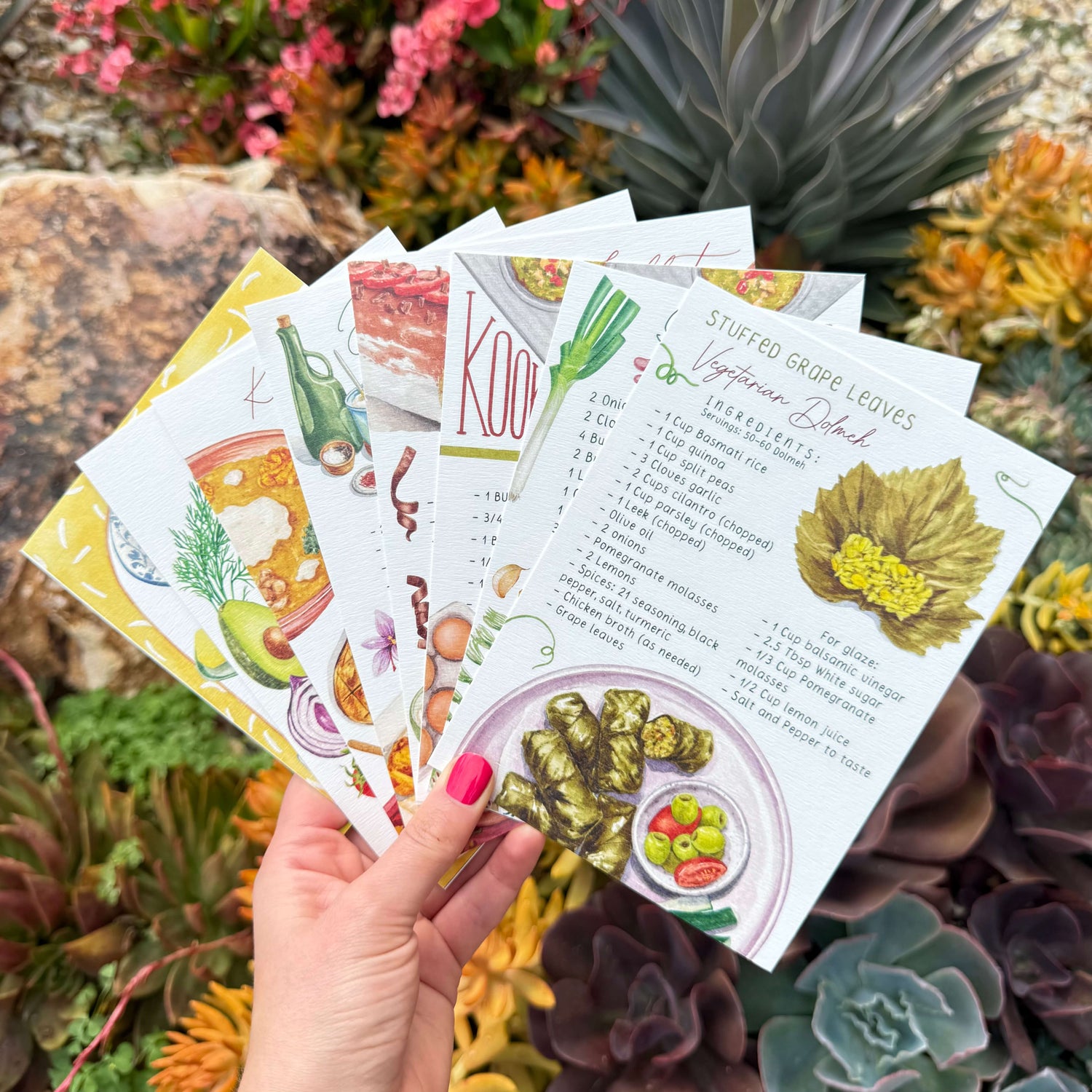Image of some of the cards in the collection fanned out. Shows food illustration with succulents in the background.